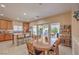 Eat-in kitchen featuring an island, wooden cabinets, stainless steel appliances, and an outdoor patio entrance at 1420 Gilbert Creek Ave, North Las Vegas, NV 89031