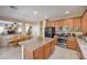 Kitchen with stainless appliances, a center island with seating, and an open dining area nearby at 1420 Gilbert Creek Ave, North Las Vegas, NV 89031