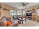 Living room with tile floors, ceiling fan, modern furniture, and a large tv at 1420 Gilbert Creek Ave, North Las Vegas, NV 89031