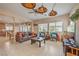 Open-concept living room featuring tile floors, a ceiling fan, and natural light from the windows at 1420 Gilbert Creek Ave, North Las Vegas, NV 89031