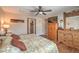 Comfortable main bedroom featuring a ceiling fan, wood-look flooring, and lots of natural light at 1420 Gilbert Creek Ave, North Las Vegas, NV 89031