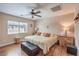 Neutral main bedroom with wood-look floors, ceiling fan, a window, and wood furniture at 1420 Gilbert Creek Ave, North Las Vegas, NV 89031