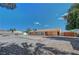 Wide view of expansive backyard with gravel, partially fenced and with covered patio at 1560 Arabian Dr, Henderson, NV 89002