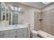 Tiled bathroom features an updated walk-in shower and modern sink and vanity at 1560 Arabian Dr, Henderson, NV 89002