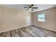 Cozy bedroom features hardwood floors, a ceiling fan and view of neighborhood at 1560 Arabian Dr, Henderson, NV 89002