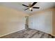 Well-lit bedroom featuring a ceiling fan, wood-look flooring, and a spacious closet at 1560 Arabian Dr, Henderson, NV 89002