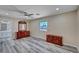 Spacious bedroom with ensuite bathroom, hardwood floors, and ceiling fan at 1560 Arabian Dr, Henderson, NV 89002
