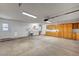 Spacious garage with ample storage cabinets, laundry area, and concrete flooring at 1560 Arabian Dr, Henderson, NV 89002