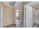 Hallway leads to rooms with hardwood flooring and updated bathroom at 1560 Arabian Dr, Henderson, NV 89002