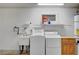 Functional laundry area with sink, washer, dryer, and storage cabinets in garage at 1560 Arabian Dr, Henderson, NV 89002