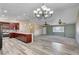 Open concept kitchen with wood cabinets flows into the spacious living room at 1560 Arabian Dr, Henderson, NV 89002
