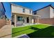 Large backyard features covered patio, artificial turf, barbecue, and low-maintenance landscaping at 1637 Harvest Pecan Ct, Las Vegas, NV 89108
