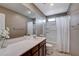 Bright bathroom features a white vanity countertop and shower with white curtain at 1637 Harvest Pecan Ct, Las Vegas, NV 89108