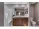 This bathroom includes a double sink vanity, large mirror, toilet, and shower with tub at 1637 Harvest Pecan Ct, Las Vegas, NV 89108