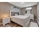 This cozy bedroom features a comfortable bed, wood-style floors, and dresser with mirror at 1637 Harvest Pecan Ct, Las Vegas, NV 89108