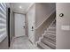 Inviting entryway featuring a staircase with wood-look steps and a modern tile floor at 1637 Harvest Pecan Ct, Las Vegas, NV 89108