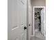Hallway featuring multiple white doors with a peek into a modern decorated powder room at 1637 Harvest Pecan Ct, Las Vegas, NV 89108