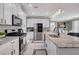 Well-equipped kitchen with granite counters, stainless appliances, and bright white cabinetry at 1637 Harvest Pecan Ct, Las Vegas, NV 89108