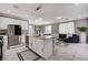 Open-concept kitchen with stainless steel appliances and island with bar seating at 1637 Harvest Pecan Ct, Las Vegas, NV 89108