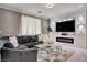 Modern living room featuring a gray sectional sofa and entertainment center at 1637 Harvest Pecan Ct, Las Vegas, NV 89108