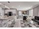 Open-concept living area with a modern kitchen island, gray sofa, and stylish decor at 1637 Harvest Pecan Ct, Las Vegas, NV 89108