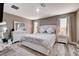 Comfortable main bedroom features a luxurious bed, wood-style floors, and dresser with mirror at 1637 Harvest Pecan Ct, Las Vegas, NV 89108