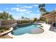 Spacious backyard with a freeform pool, desert landscaping, and covered patio for outdoor relaxation at 188 Carthage St, Henderson, NV 89074
