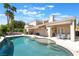 Stunning backyard pool with a sunshade, lounge chairs, and landscaped garden at 188 Carthage St, Henderson, NV 89074