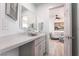 Bright bathroom with a unique clear glass vessel sink and view into the living room at 188 Carthage St, Henderson, NV 89074
