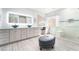 Bright bathroom featuring dual sinks, vanity area, and glass enclosed shower at 188 Carthage St, Henderson, NV 89074