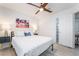 A bright bedroom with ceiling fan, walk-in closet and colorful beach themed artwork above the bed at 188 Carthage St, Henderson, NV 89074