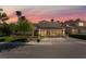 Beautiful two-story home at sunset with well-maintained landscaping, a three-car garage, and a spacious driveway at 188 Carthage St, Henderson, NV 89074