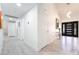 Bright foyer with light wood floors, a modern front door, and neutral wall colors at 188 Carthage St, Henderson, NV 89074