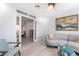 Bright living room with wood floors, modern furniture, and a decorative painting at 188 Carthage St, Henderson, NV 89074