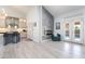 Bright living area with open kitchen, stone fireplace, access to patio, and stylish decor at 188 Carthage St, Henderson, NV 89074