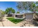 A spacious backyard features gravel landscaping, an awning, and artificial turf at 212 View Dr, Las Vegas, NV 89107