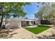 A spacious backyard features gravel landscaping, an awning, and artificial turf at 212 View Dr, Las Vegas, NV 89107