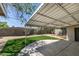 A backyard with artificial grass and a covered patio area perfect for outdoor living at 212 View Dr, Las Vegas, NV 89107