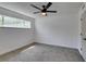 This bedroom features neutral paint, carpeted floors, a ceiling fan, and a window at 212 View Dr, Las Vegas, NV 89107