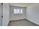 This bedroom features neutral paint, carpeted floors, and a window at 212 View Dr, Las Vegas, NV 89107