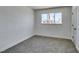 Empty bedroom featuring neutral carpet, large window, and modern trim at 212 View Dr, Las Vegas, NV 89107