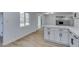 Modern kitchen features gray cabinets, stainless appliances, and flows into dining area at 212 View Dr, Las Vegas, NV 89107