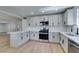 A modern, renovated kitchen with white cabinets, stainless steel appliances, and an open design at 212 View Dr, Las Vegas, NV 89107
