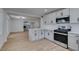 Modern kitchen features gray cabinets, stainless appliances, and flows into living room at 212 View Dr, Las Vegas, NV 89107