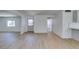 Open floor plan with light wood floors connecting the kitchen and living areas at 212 View Dr, Las Vegas, NV 89107