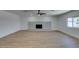 Spacious living room with a decorative fireplace and light wood floors at 212 View Dr, Las Vegas, NV 89107