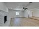 Spacious open-concept living area with light wood floors and a white brick fireplace at 212 View Dr, Las Vegas, NV 89107