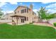 A spacious backyard with a covered patio, lush lawn, and ample room for outdoor activities at 2257 Norway Pine Ct, Las Vegas, NV 89134