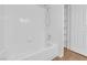White bathroom with shower/tub combo and tiled walls at 2257 Norway Pine Ct, Las Vegas, NV 89134