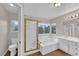 Inviting bathroom with walk-in shower, soaking tub, and vanity at 2257 Norway Pine Ct, Las Vegas, NV 89134